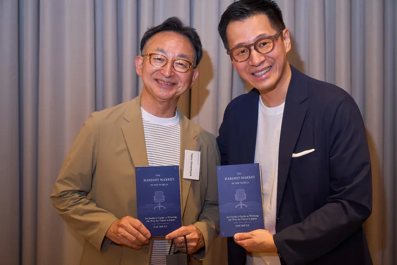 Yan Sen Lu with a guest and copies of the book