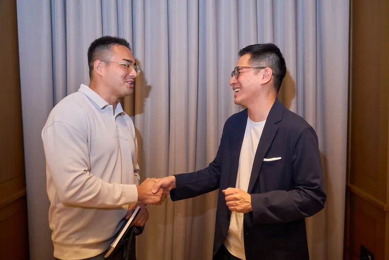 A handshake between guests at the launch